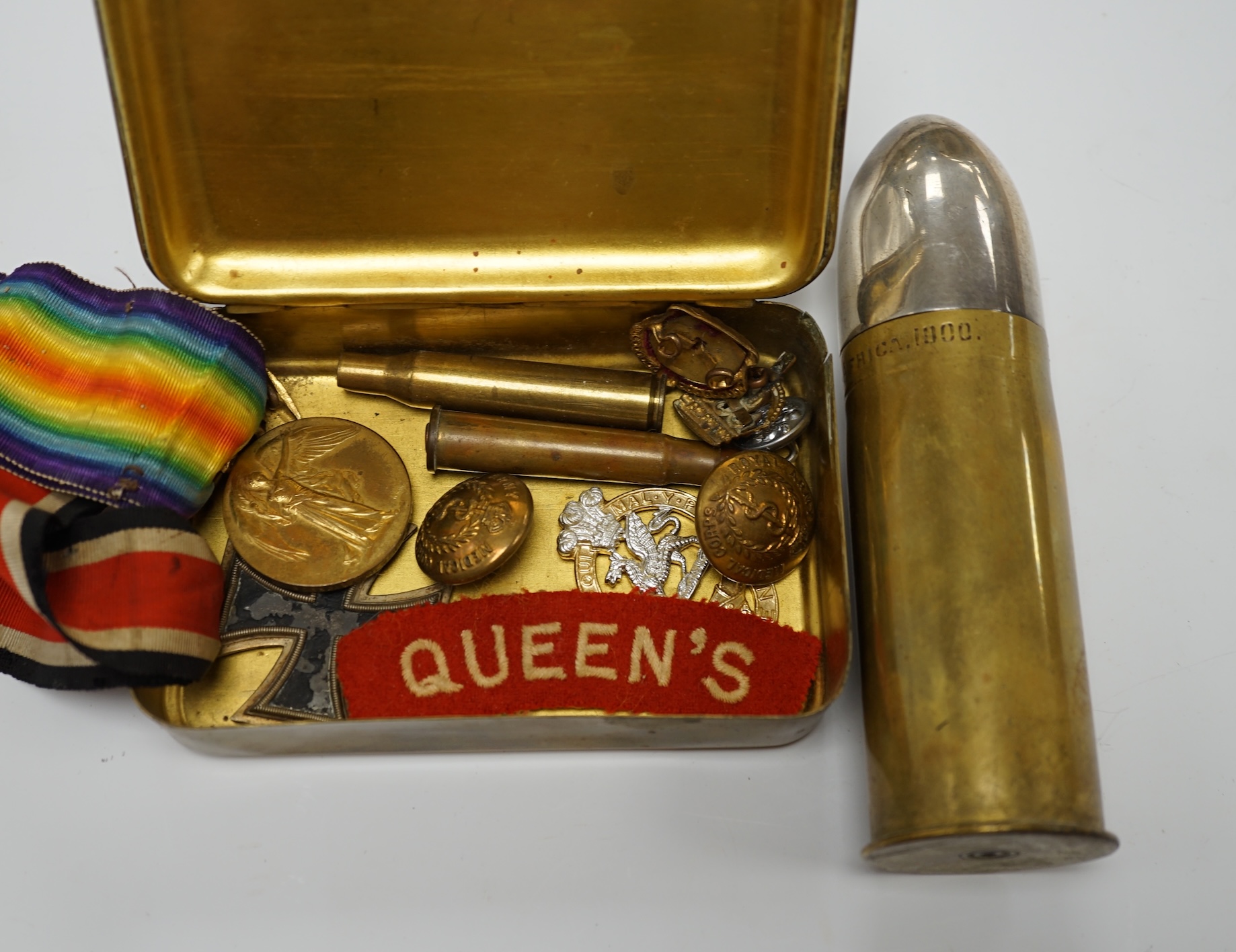 A collection of First World War memorabilia, including; a Victory Medal awarded to Gnr. W.R.P. Harris R.A., a Second Class Iron Cross, plus some buttons and badges contained within a Princess Mary Christmas tin, and a sh